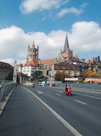 City street against cloudy sky