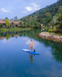 Rear view of man in boat in lake