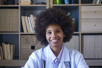 Smiling doctor sitting in clinic