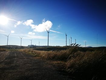 Windmill on field against sky