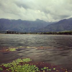 Scenic view of lake against cloudy sky