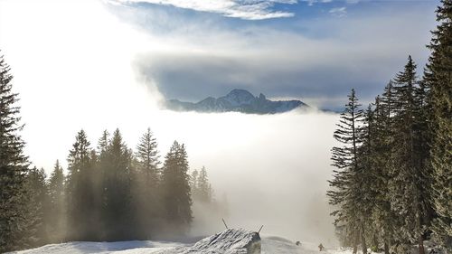 Scenic view of snow covered mountains against sky