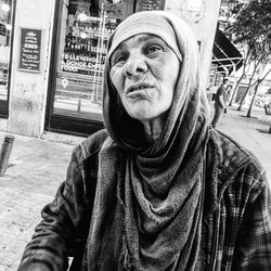 Portrait of man standing on street in city