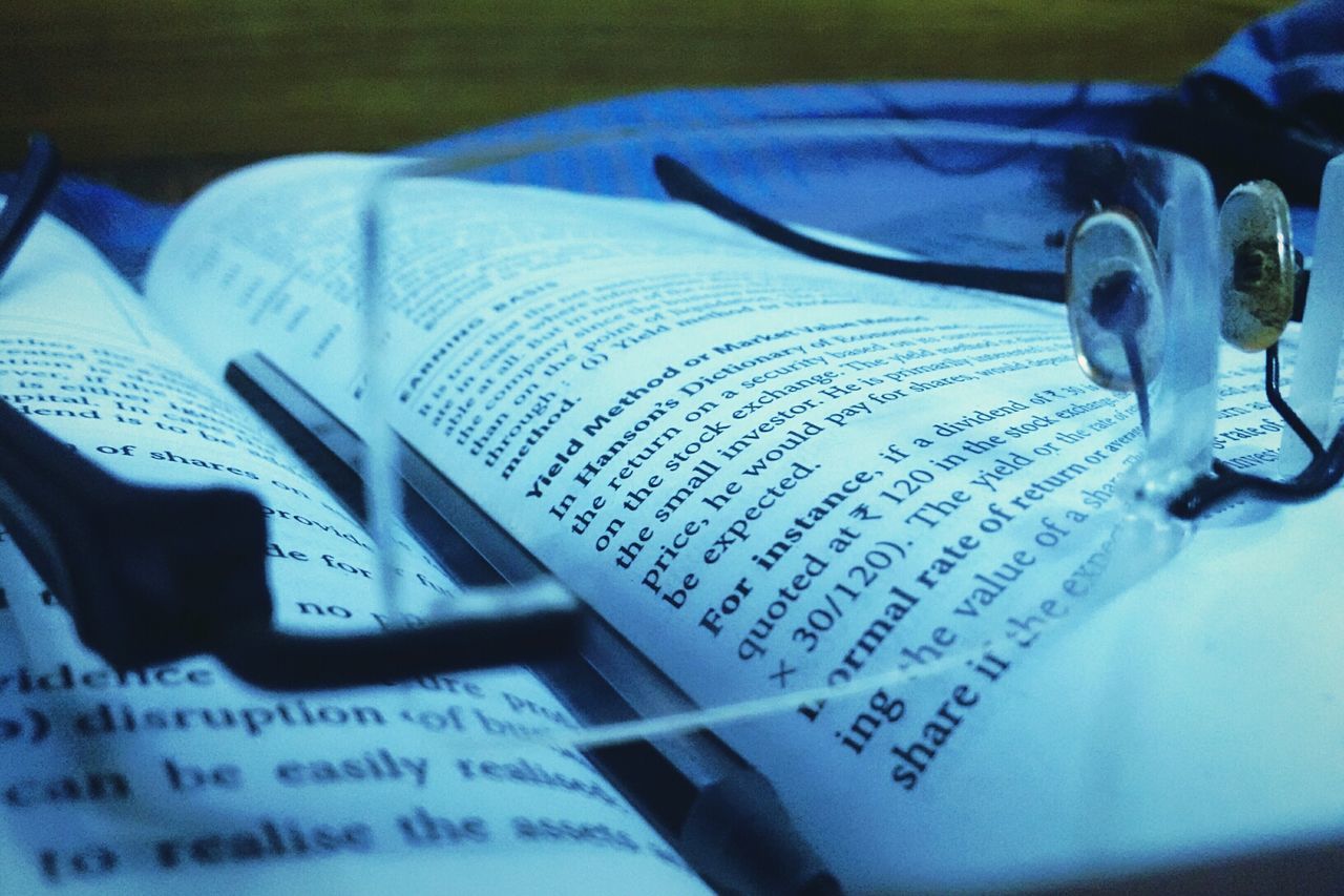 close-up, indoors, text, communication, western script, selective focus, still life, paper, number, book, part of, pen, technology, focus on foreground, high angle view, metal, education, music, no people, detail