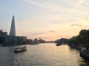 High angle view of ferry sailing on thames river against buildings in city