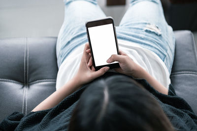 Midsection of man using mobile phone