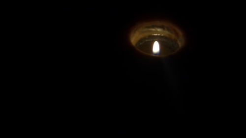 Close-up of illuminated light bulb in the dark