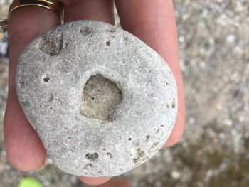 Close-up of person holding water formed rock