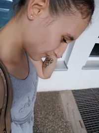 Midsection of young woman standing with arms raised