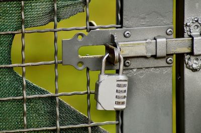 Close-up of padlocks on metal fence