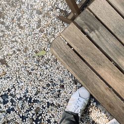 Low section of person standing on pebbles