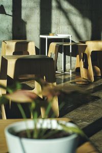 Close-up of empty chairs and table in cafe