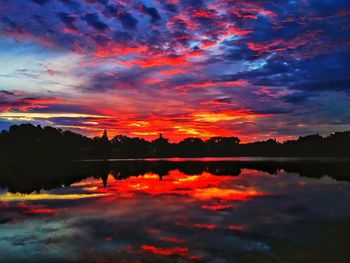 Scenic view of lake against orange sky