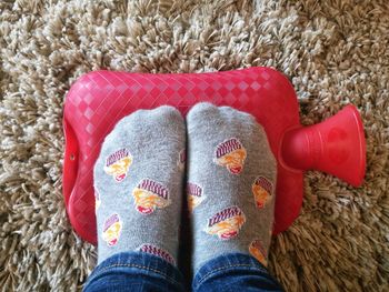 Low section of woman relaxing on rug