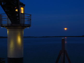 Scenic view of sea against clear blue sky at dusk