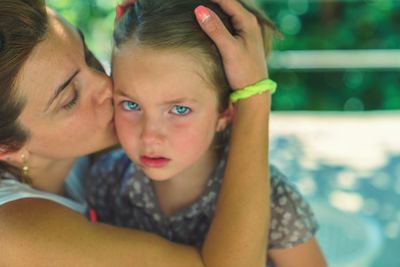 Close-up of mother and daughter in swimming pool