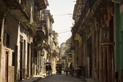 Empty alley amidst buildings in city