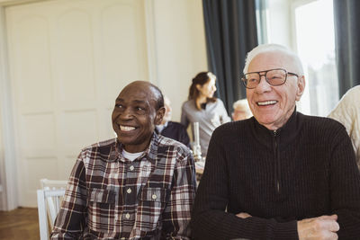 Cheerful senior male friends in nursing home