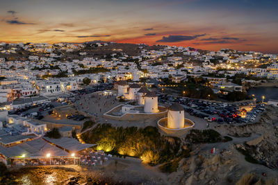 Drone view of illuminated townscape against sky during sunset