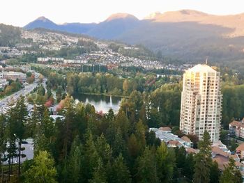 High angle view of townscape by lake in city