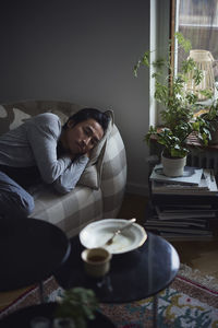 Sad man facing depression lying in bed