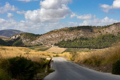 Road amidst landscape against sky