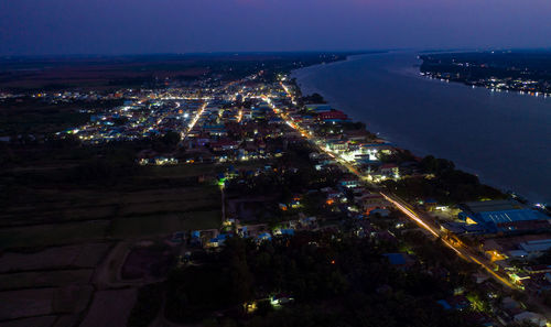 High angle view of city lit up at night