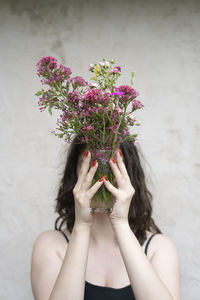 Midsection of woman holding bouquet