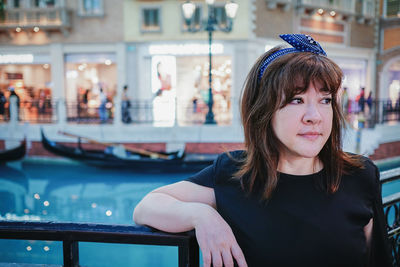 Portrait of woman against railing