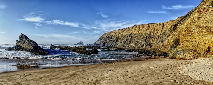 Scenic view of beach against sky