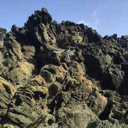 Low angle view of rocks against sky