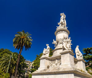 Low angle view of statue against blue sky