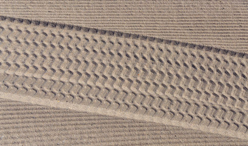 High angle view of tire tracks on land