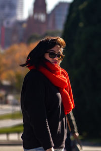 Side view of young woman standing outdoors