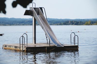 Close-up of boat in lake against sky