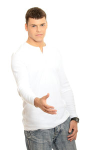 Portrait of young man standing against white background