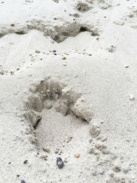 High angle view of footprints on sand at beach