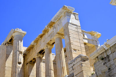 Low angle view of historic building against blue sky