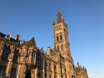 Low angle view of clock tower against sky in city