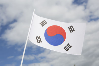 Low angle view of flag against sky