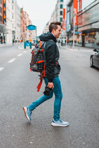 Full length of man standing on road in city