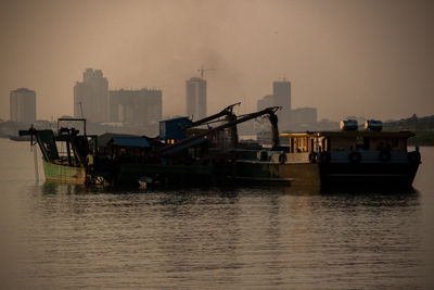 Boats in sea against clear sky