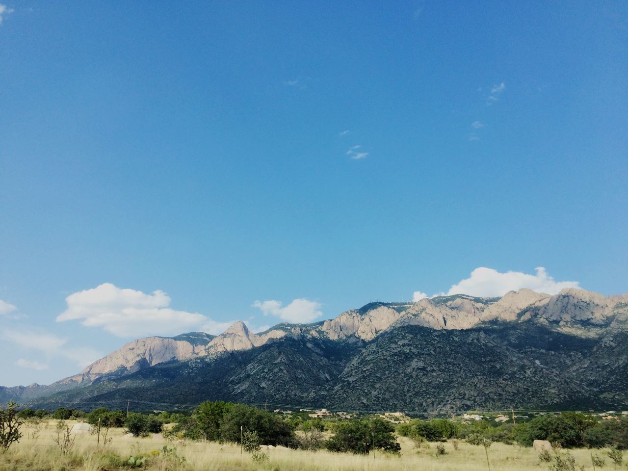 mountain, mountain range, tranquil scene, tranquility, landscape, scenics, blue, beauty in nature, sky, nature, non-urban scene, remote, idyllic, day, physical geography, outdoors, cloud, hill, sunlight, non urban scene