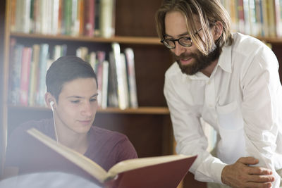 High school student in library with librarian