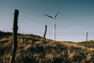 Windmill on field against sky