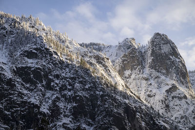 Low angle view of snowcapped mountain against sky