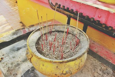 High angle view of incense sticks in container