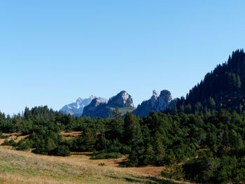 Scenic view of mountains against clear blue sky