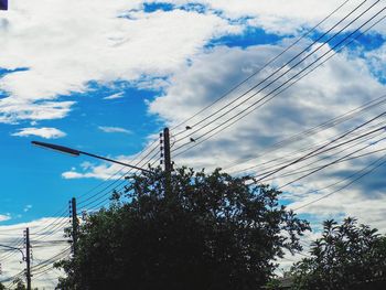 Low angle view of electricity pylon against sky