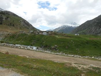 Scenic view of mountains against cloudy sky